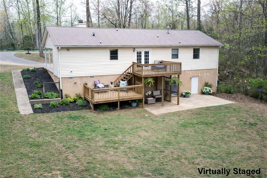 2976 Sweetwater Juno Road Dawsonville, GA 30534 - Photo 35 of 42 a view of a house with backyard porch and sitting area