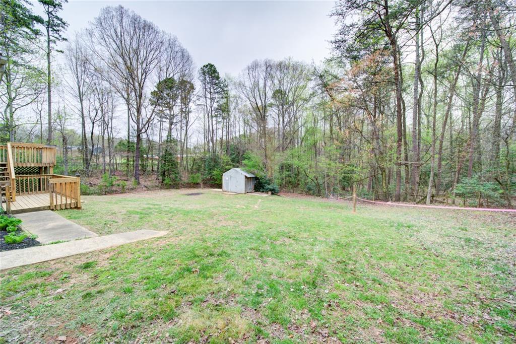 2976 Sweetwater Juno Road Dawsonville, GA 30534 - Photo 37 of 42 a backyard of a house with lots of green space and trampoline