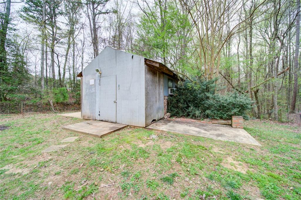2976 Sweetwater Juno Road Dawsonville, GA 30534 - Photo 38 of 42 a backyard of a house with lots of green space