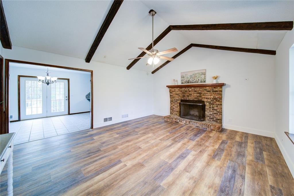 2976 Sweetwater Juno Road Dawsonville, GA 30534 - Photo 5 of 42 a view of empty room with wooden floor and fireplace