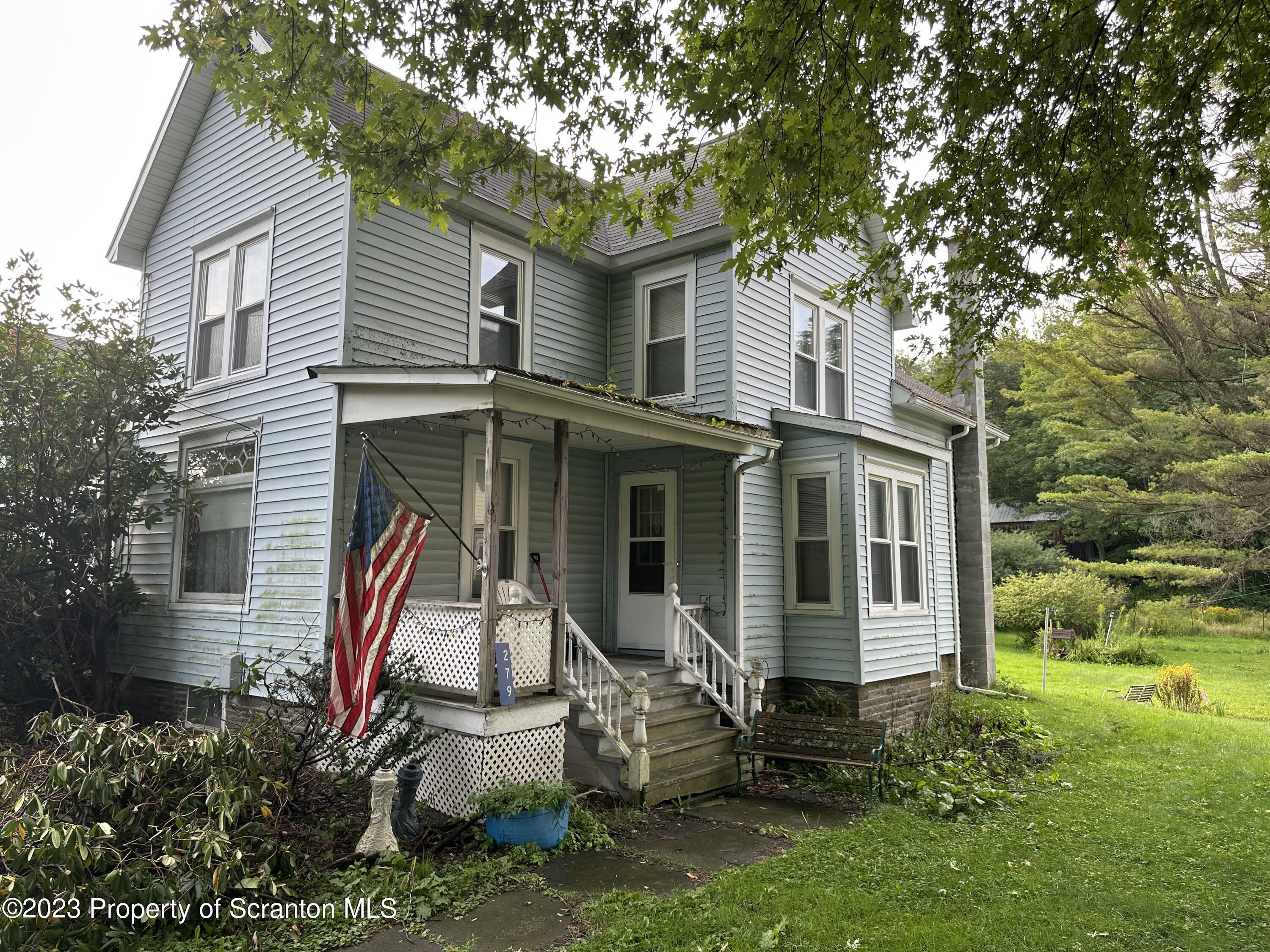 279 Jackson Street Thompson, PA 18465 - Photo 2 of 6 front view of a house with a yard