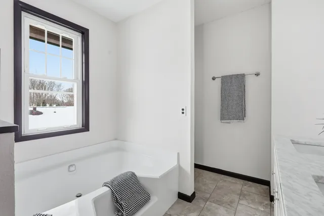 a bathroom with a bathtub and shower