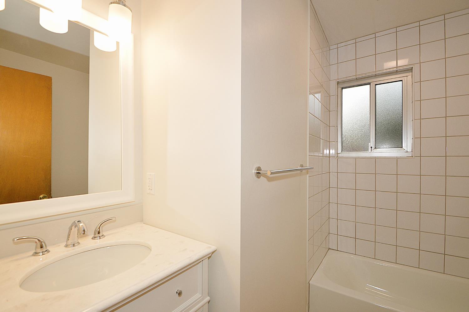 3860 East Rialto Avenue Fresno, CA 93726 - Photo 5 of 8 a bathroom with a sink a toilet and shower