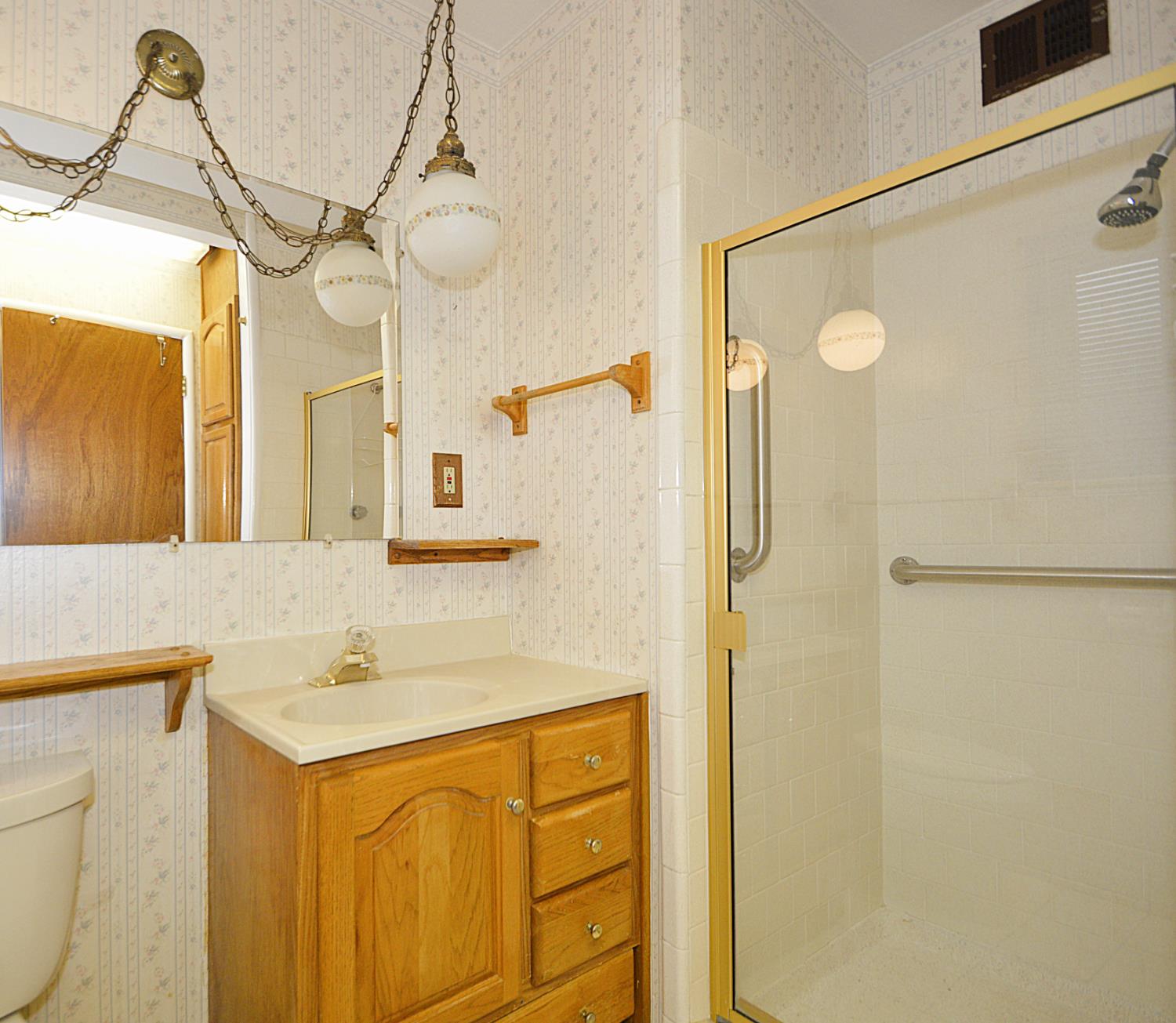 3860 East Rialto Avenue Fresno, CA 93726 - Photo 6 of 8 a bathroom with a sink a mirror and a shower