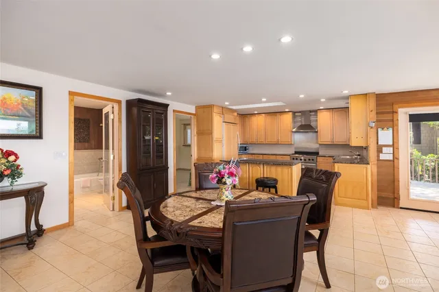 a kitchen with stainless steel appliances granite countertop a refrigerator and a stove top oven