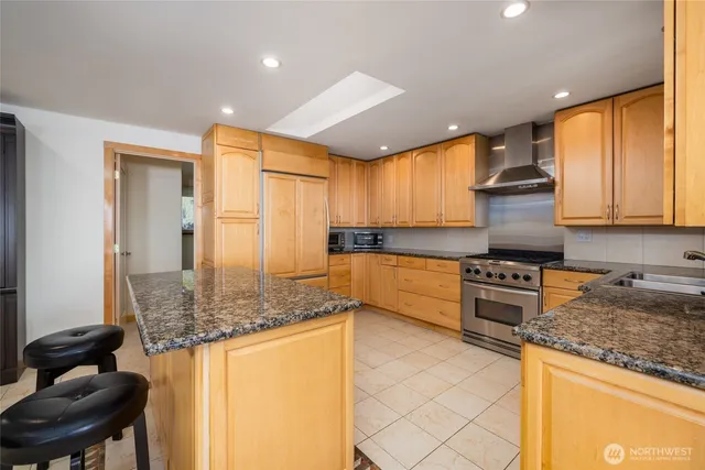 a kitchen with stainless steel appliances a refrigerator and cabinets
