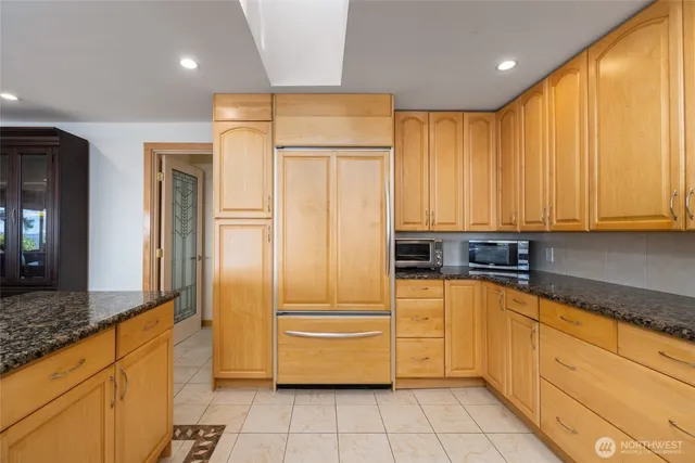 a kitchen with stainless steel appliances granite countertop a sink and cabinets