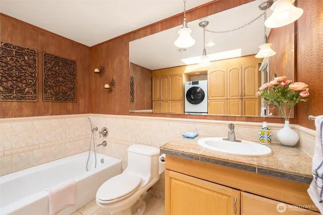 a bedroom with bed and a painting on the wall