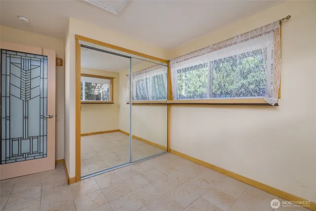 a view of a patio with a table and chairs under an umbrella