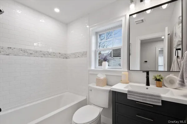 a bathroom with a bathtub and shower