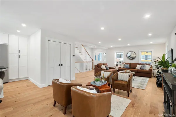 a living room with furniture flat screen tv and a window