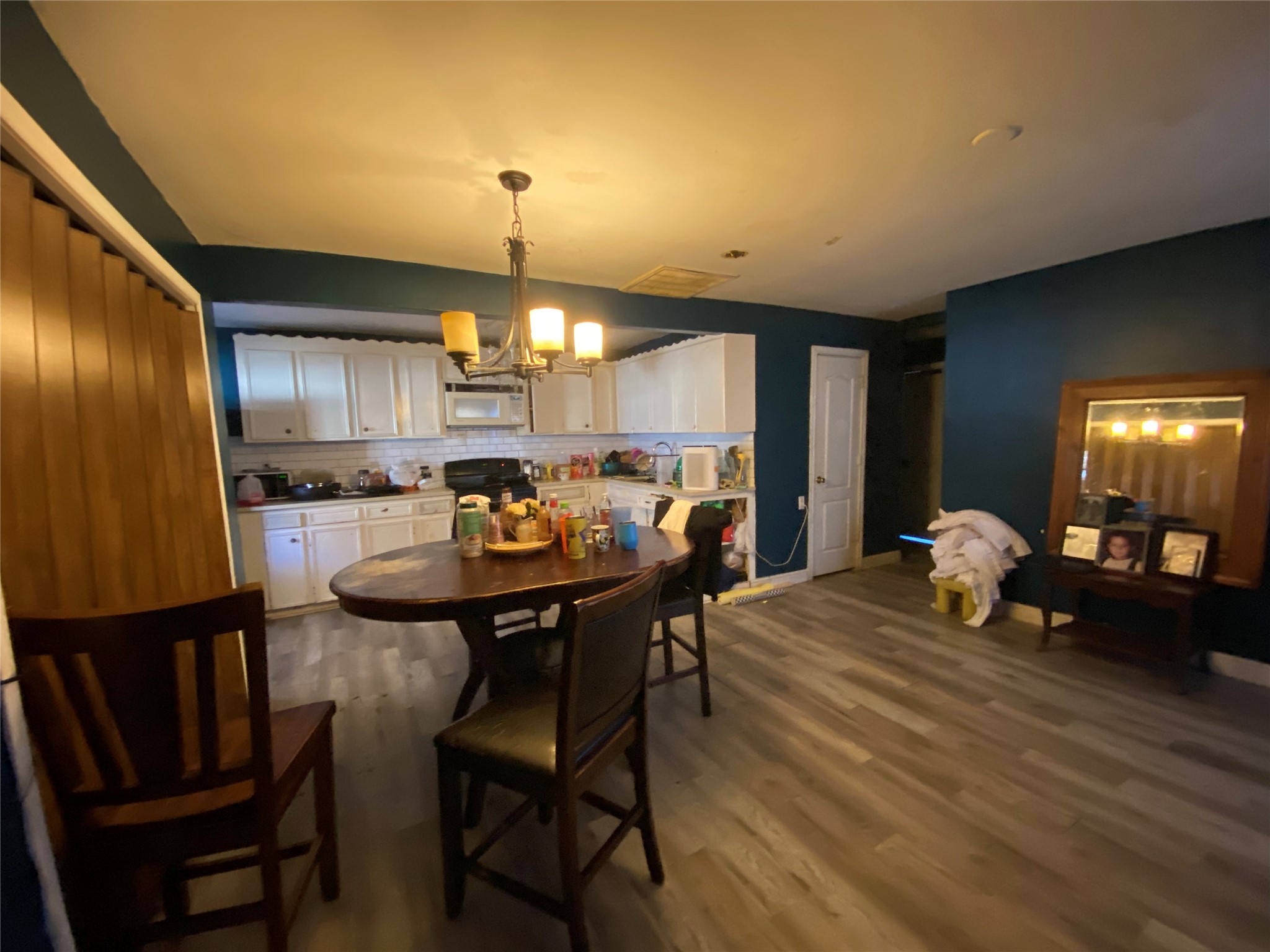 3147 Golfcrest Boulevard Houston, TX 77087 - Photo 12 of 27 a kitchen with stainless steel appliances kitchen island granite countertop a table chairs and a refrigerator