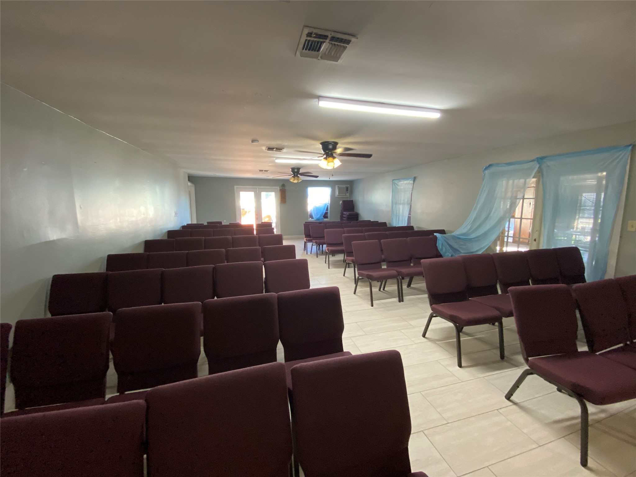 3147 Golfcrest Boulevard Houston, TX 77087 - Photo 15 of 27 a media room with lots of chairs and a projector screen