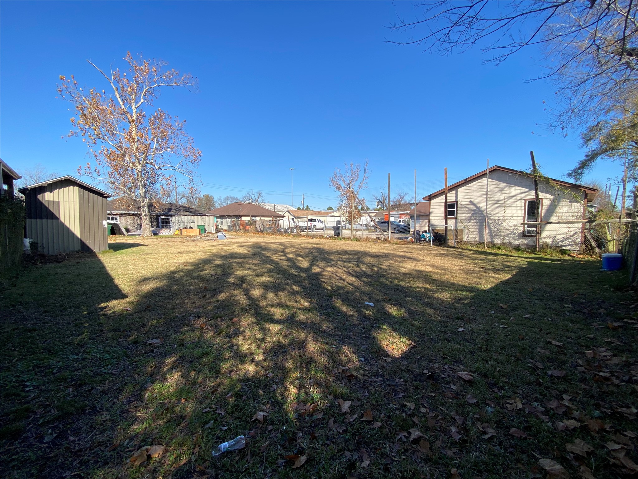 3147 Golfcrest Boulevard Houston, TX 77087 - Photo 23 of 27 a view of a yard with table and chairs under an umbrella