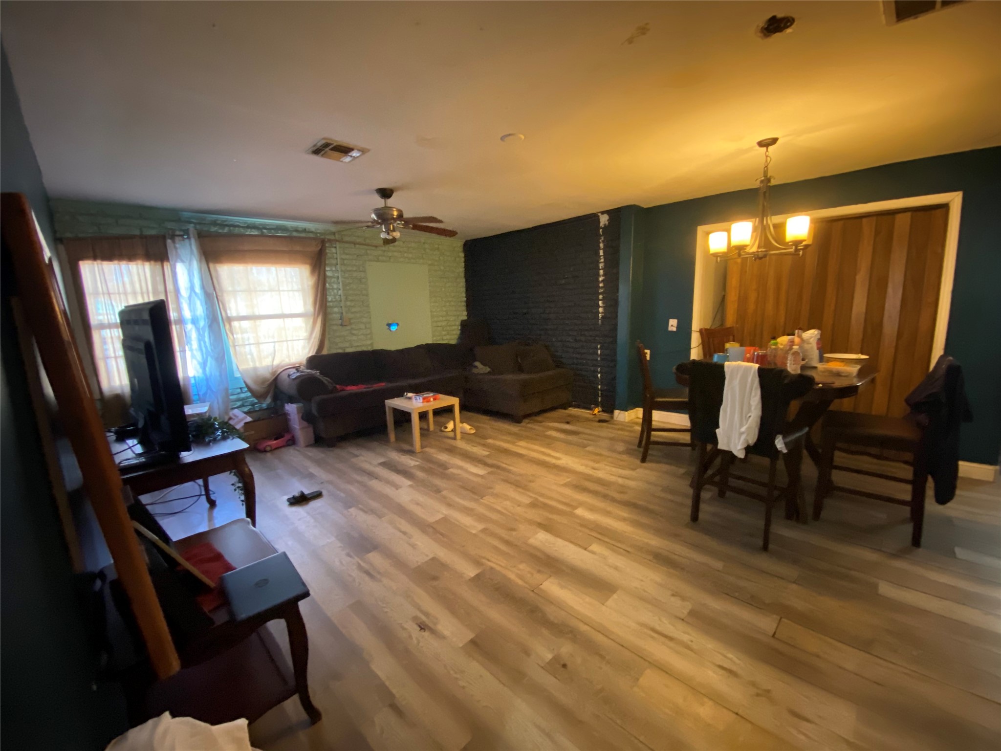3147 Golfcrest Boulevard Houston, TX 77087 - Photo 5 of 27 a living room with furniture a dining table and a flat screen tv