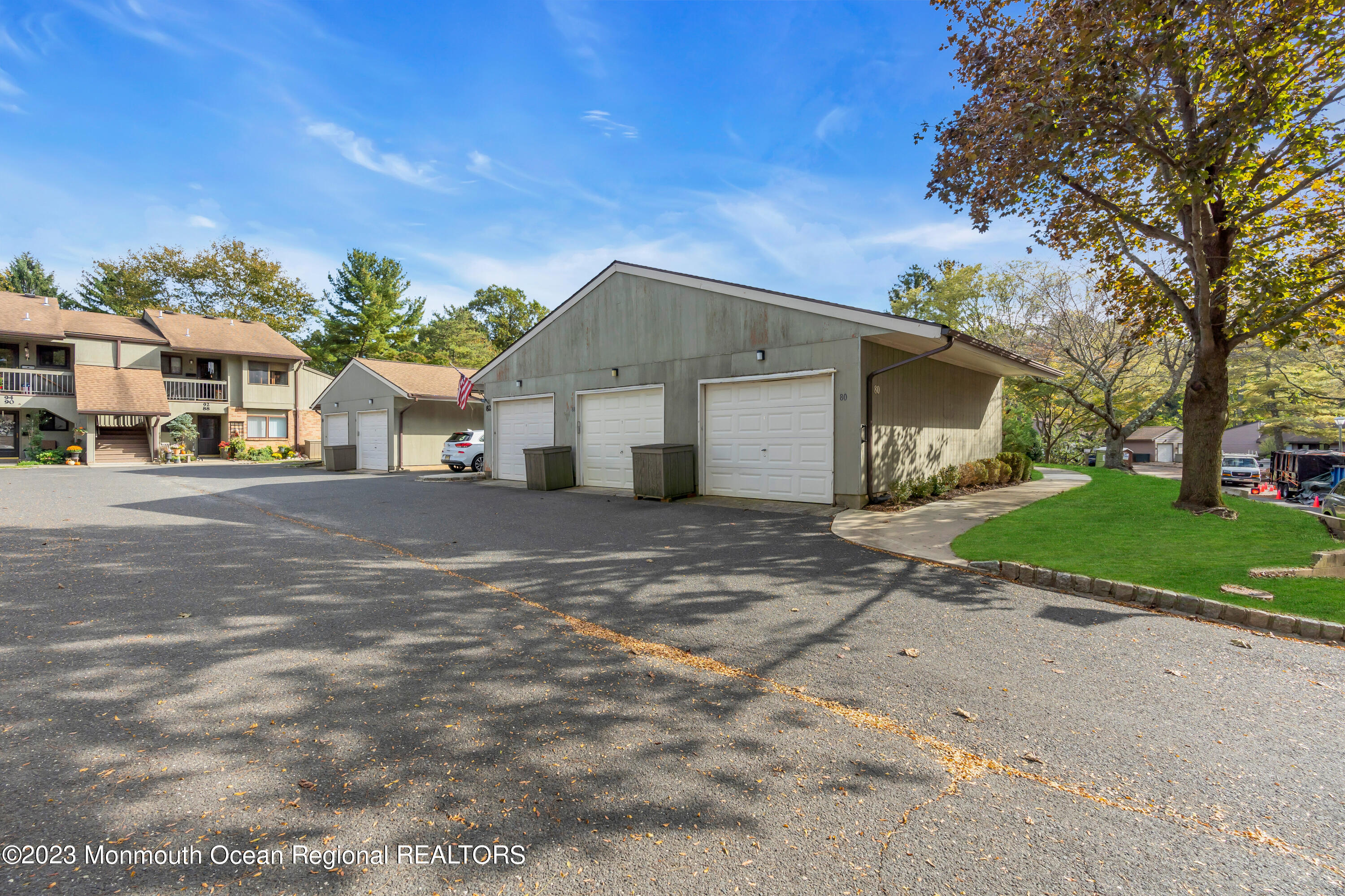 80 Friendship Court Red Bank, NJ 07701 - Photo 23 of 25 a front view of a house with a yard and garage