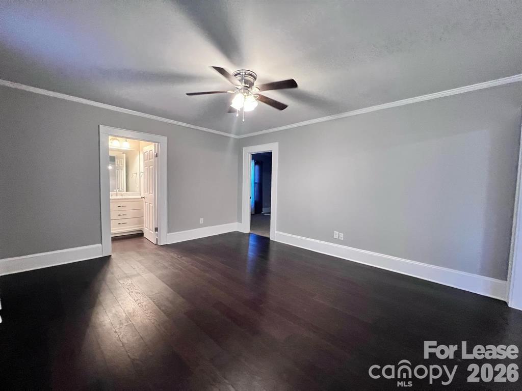 2104 Moose Road Kannapolis, NC 28083 - Photo 8 of 20 a view of an empty room with wooden floor and a ceiling fan