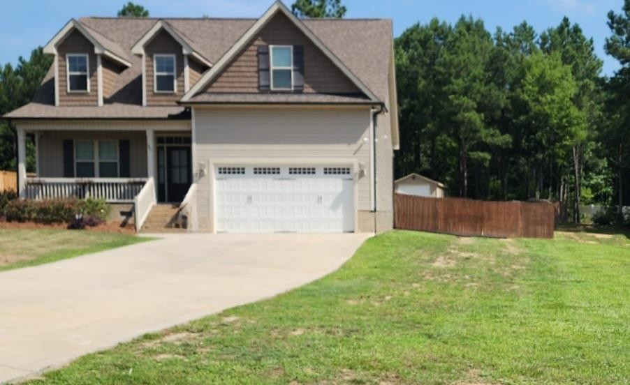 465 Redwood Road Zebulon, NC 27597 - Photo 2 of 3 a front view of a house with a yard and garage