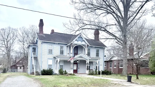 a front view of a house with a yard