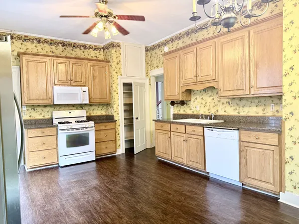 a kitchen with stainless steel appliances a stove a sink and a refrigerator