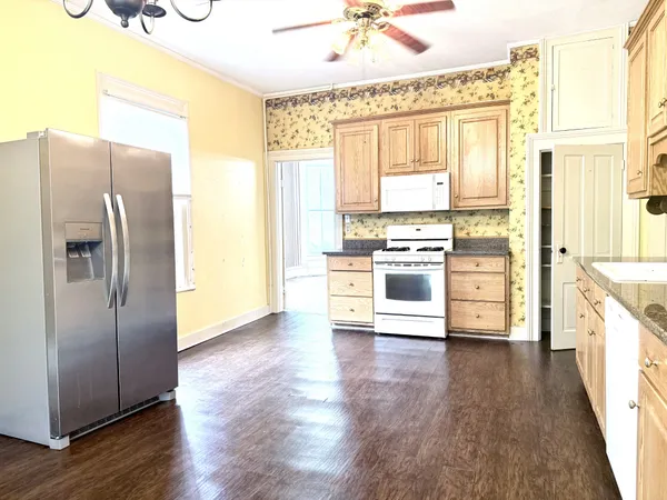 a kitchen with stainless steel appliances a stove top oven and a refrigerator