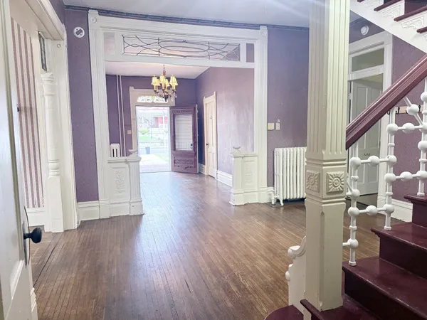 a view of an entryway with wooden floor and door