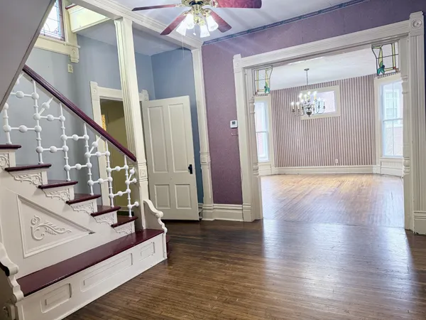 a view of an entryway with wooden floor and stair