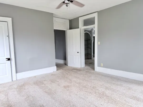 a view of an empty room with a ceiling fan