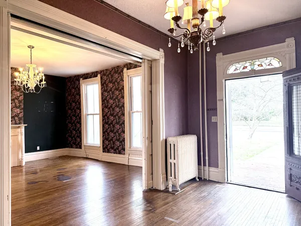 a view of a room with wooden floor and stairs