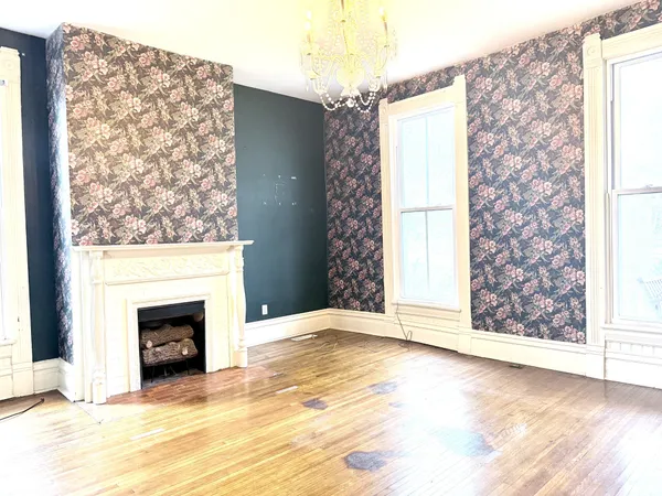 a view of empty room with window and fireplace