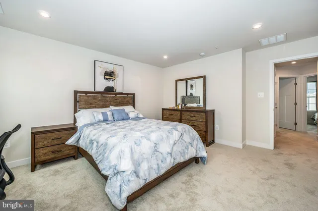 a bedroom with a bed and a dresser