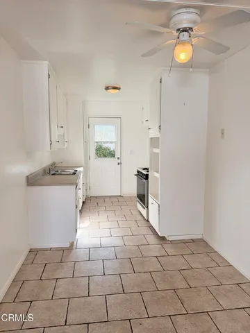 a view of a kitchen with a stove cabinets and a kitchen view