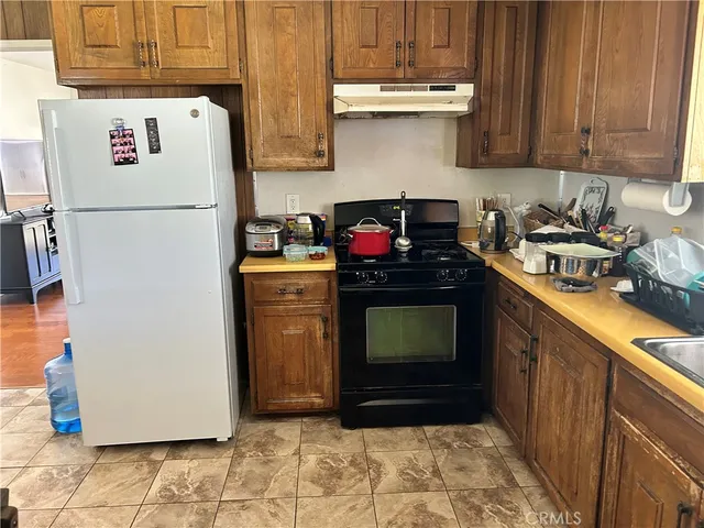 a kitchen with a refrigerator and a stove