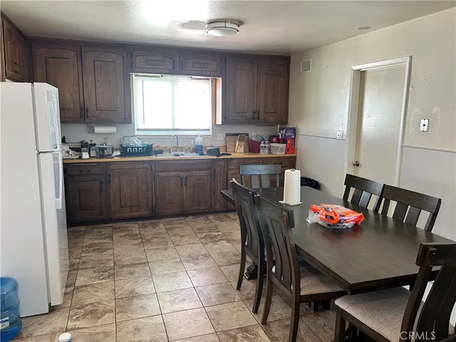 a kitchen with granite countertop a dining table and chairs
