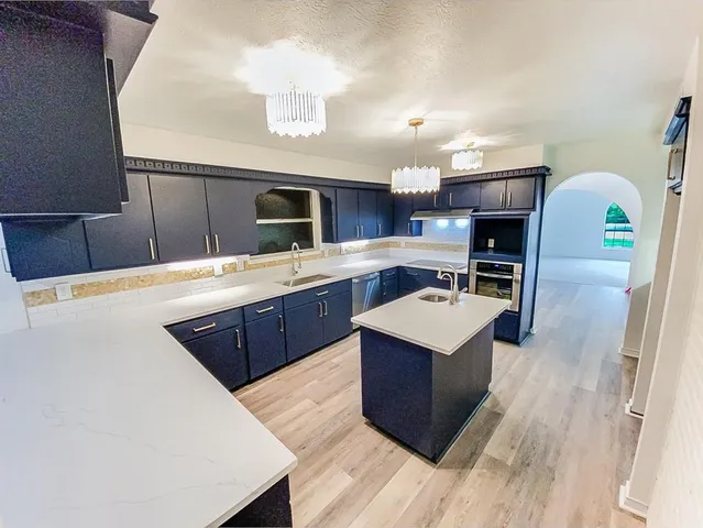 a kitchen with a sink a stove and a refrigerator