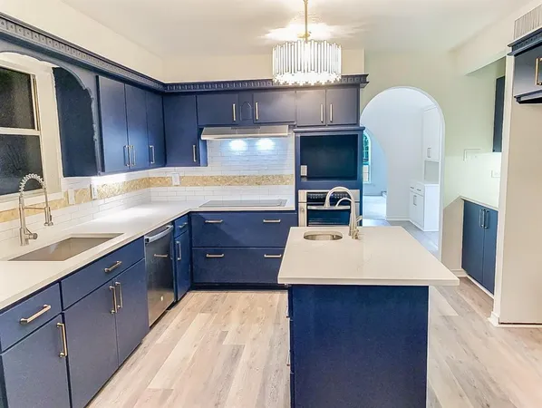 a kitchen with a sink stainless steel appliances and cabinets