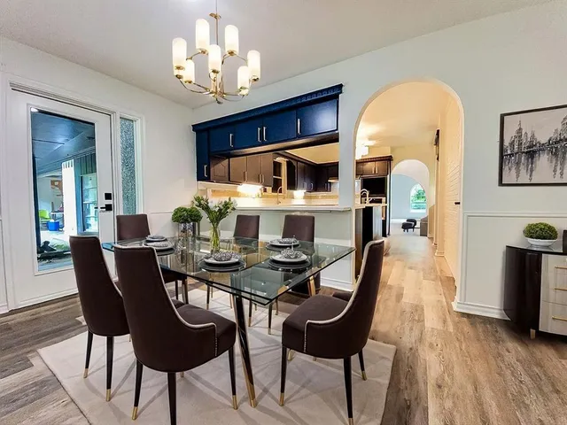 a view of a dining room with furniture and wooden floor
