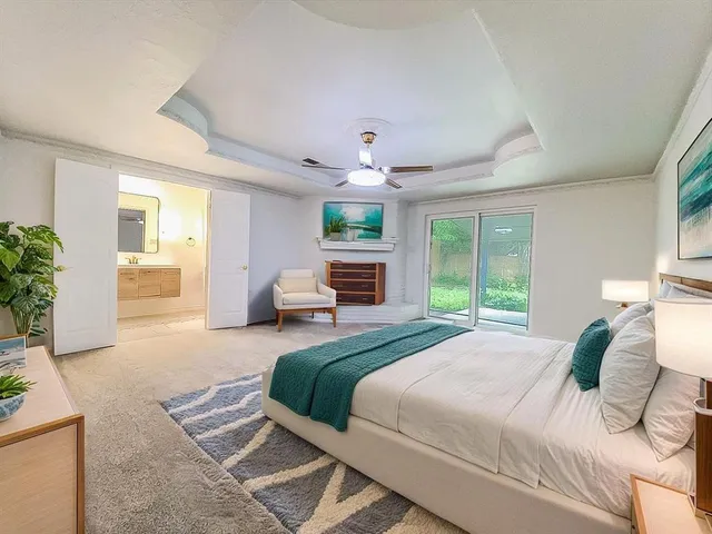 a bedroom with a large bed and a large window