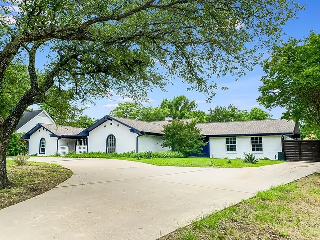 a house with lots of trees in the background