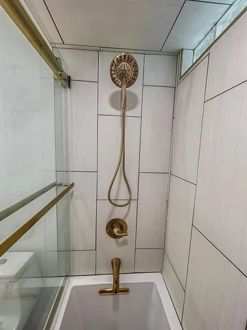 a bathroom with a shower and a window