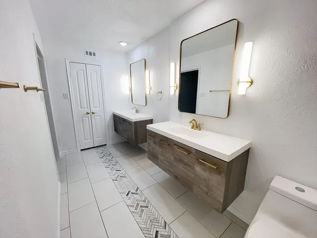 a bathroom with a sink a mirror and vanity
