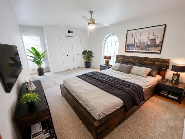 a bedroom with bed and a couch