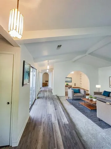 a living room with furniture and a wooden floor