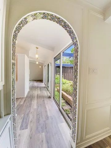 a view of a hallway with wooden floor