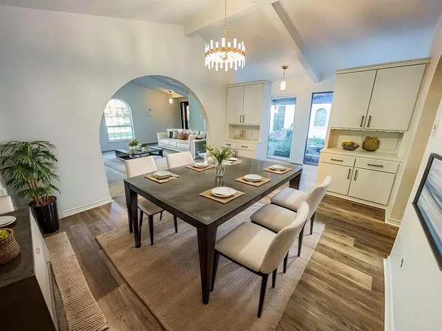 a view of a dining room with furniture and a chandelier