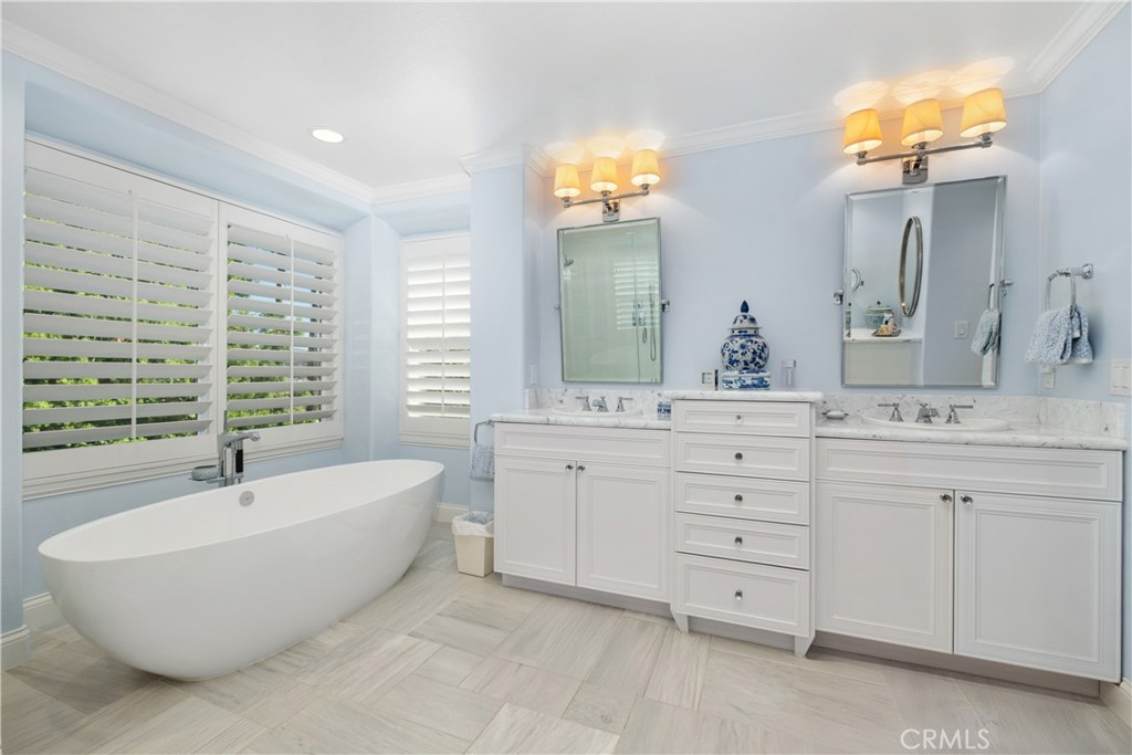 6 Muirfield Rancho Santa Margarita, CA 92679 - Photo 23 of 49 a spacious bathroom with a double vanity sink a mirror a bathtub and next to a window