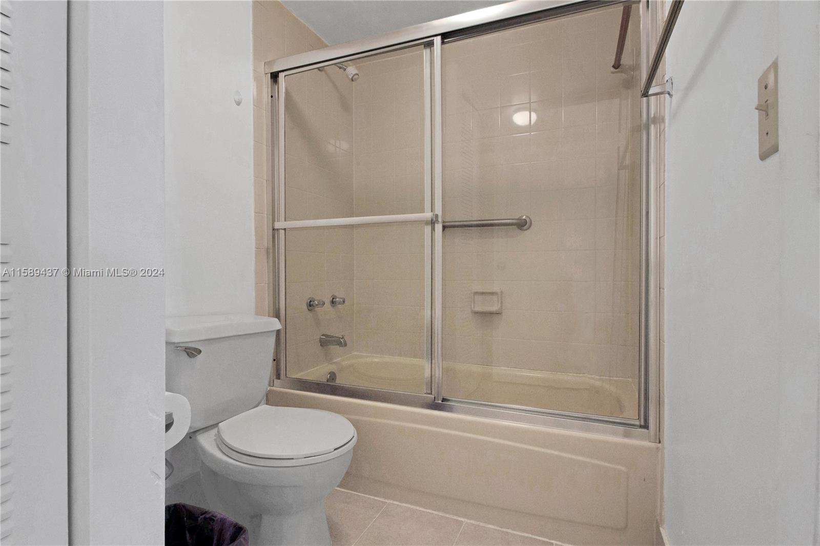 8650 Southwest 212th Street, Unit 101 Cutler Bay, FL 33189 - Photo 25 of 29 a bathroom with a shower a toilet and a sink