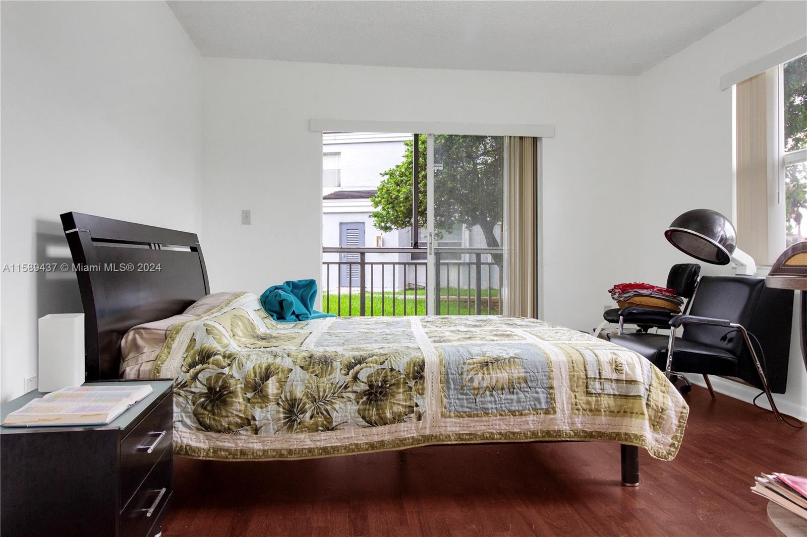 8650 Southwest 212th Street, Unit 101 Cutler Bay, FL 33189 - Photo 28 of 29 a bedroom with bed and wooden floor