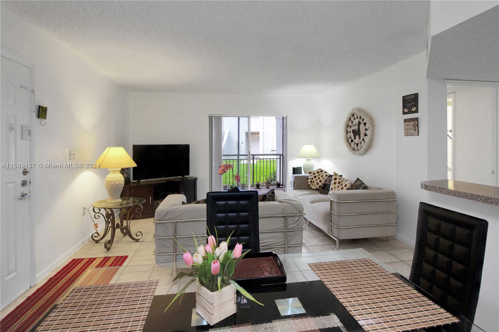 8650 Southwest 212th Street, Unit 101 Cutler Bay, FL 33189 - Photo 29 of 29 a living room with furniture and a flat screen tv