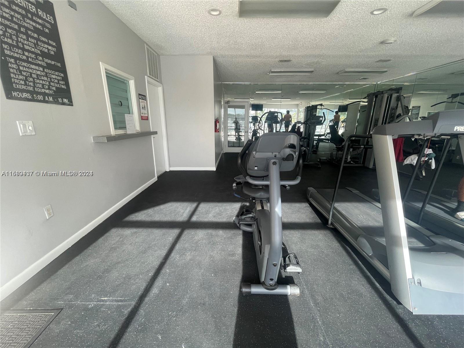 8650 Southwest 212th Street, Unit 101 Cutler Bay, FL 33189 - Photo 8 of 29 a view of a room with gym equipment